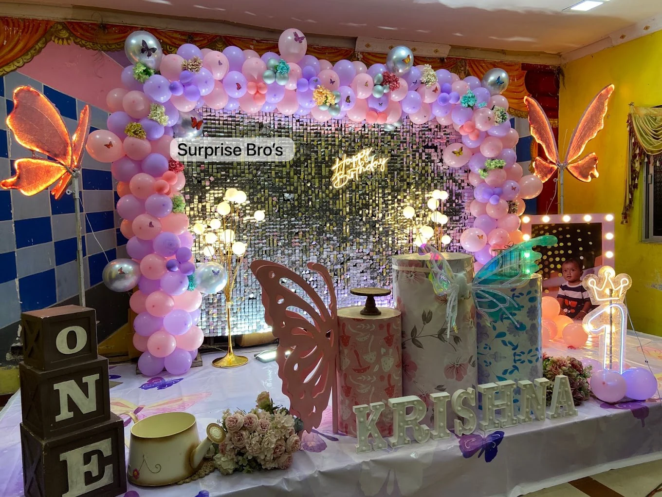 Pink and lavender butterfly birthday stage with a silver sequin wall
