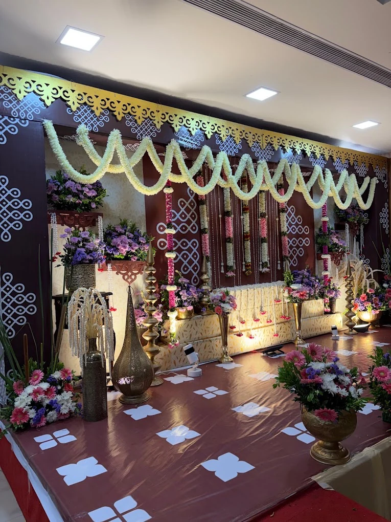 Traditional floral stage with jasmine garlands and brass lamps